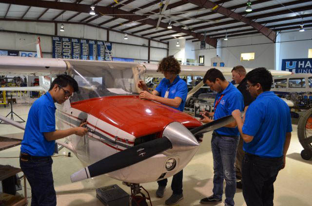 Aeronautics Students Work On Plane in Hangar Photo