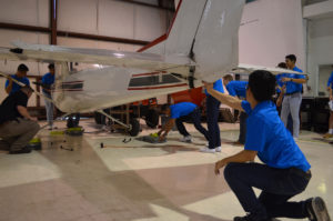 Aero chi cohort 1 students working on plane