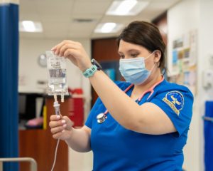 A nursing student handles an IV Drip during an exercise in the School of Nursing