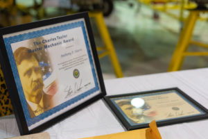 Anthony Harris's Charles Taylor Master Mechanic Award stands on a table at the College of Aeronautics