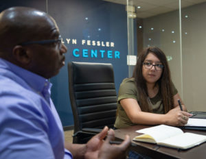 A student listens to her instructor in Hallmark University's School of Business
