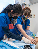 Students work together during a simulation exercise in the School of Nursing